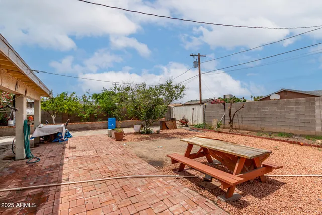 a view of a porch with dining table and chairs