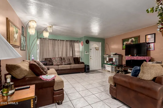 a living room with furniture and a chandelier
