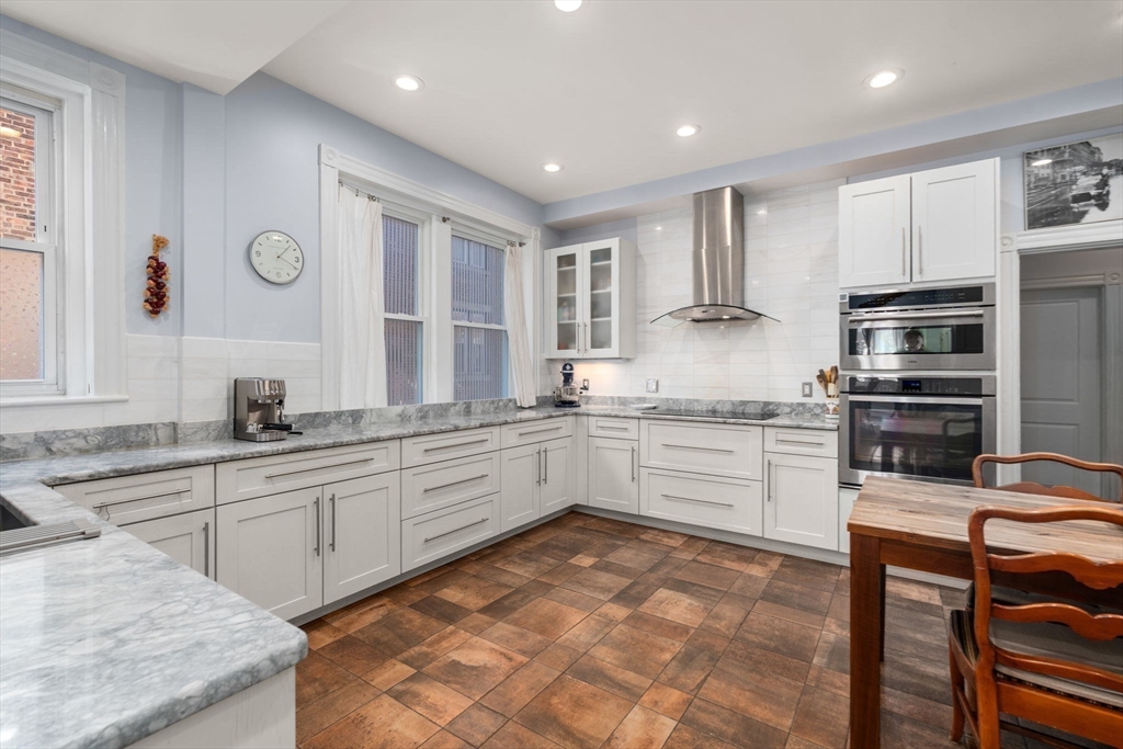 7 Parkman Street, Unit 1 Brookline, MA 02446 - Photo 12 of 27 a kitchen with granite countertop a sink appliances cabinets and furniture