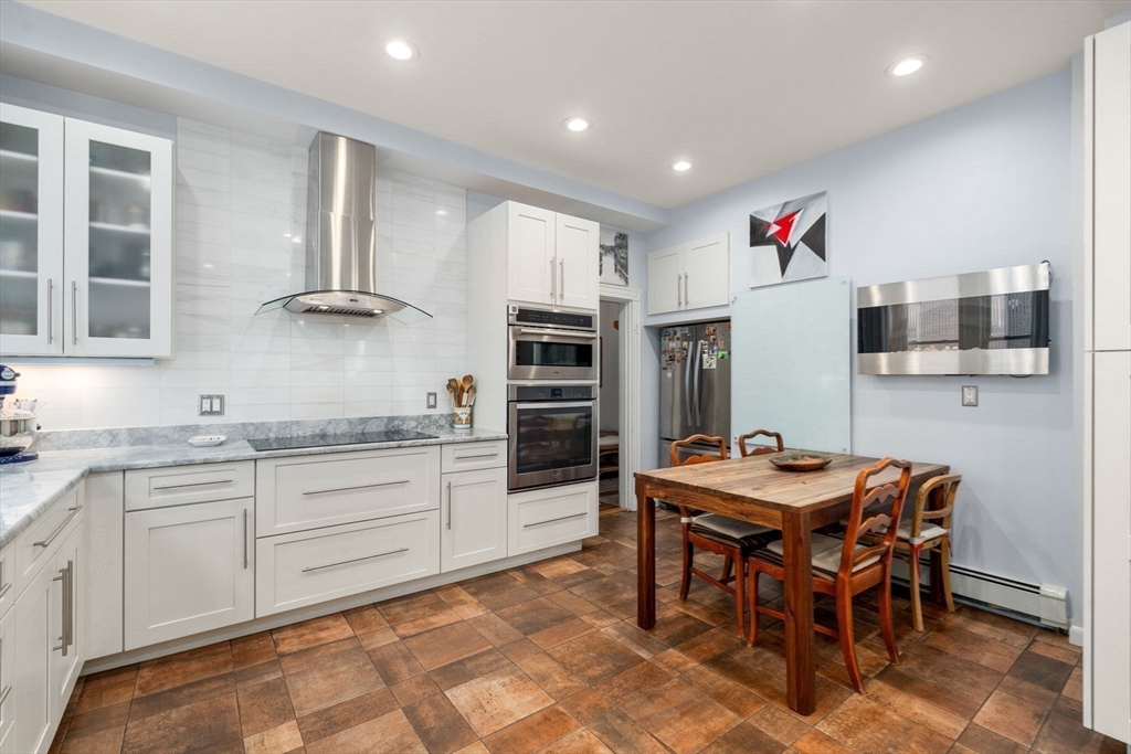 7 Parkman Street, Unit 1 Brookline, MA 02446 - Photo 13 of 27 a kitchen with stainless steel appliances granite countertop a sink and a refrigerator