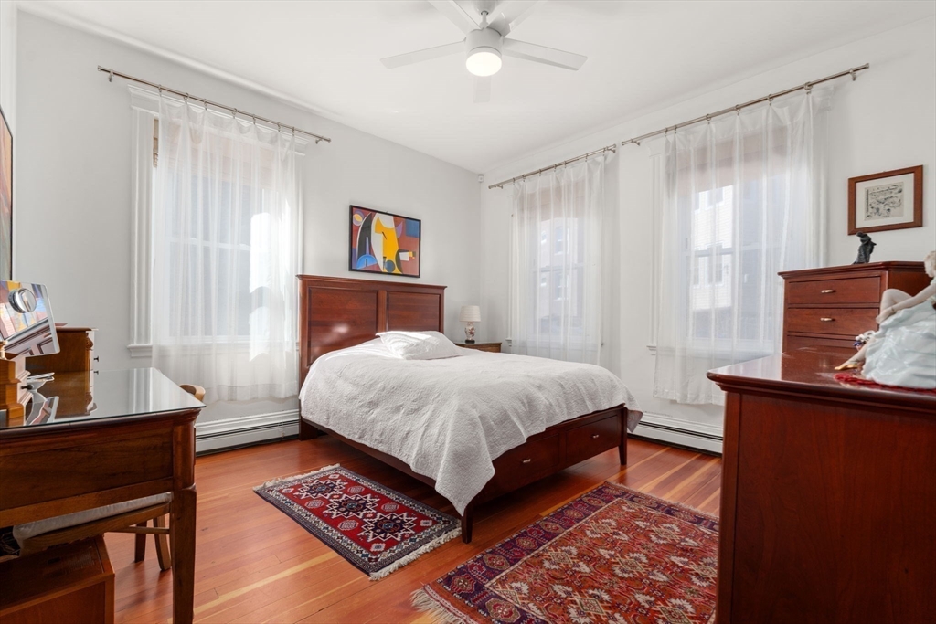 7 Parkman Street, Unit 1 Brookline, MA 02446 - Photo 16 of 27 a bedroom with a bed and a dresser in it