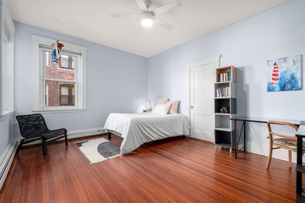 7 Parkman Street, Unit 1 Brookline, MA 02446 - Photo 17 of 27 a bedroom with a bed and wooden floor