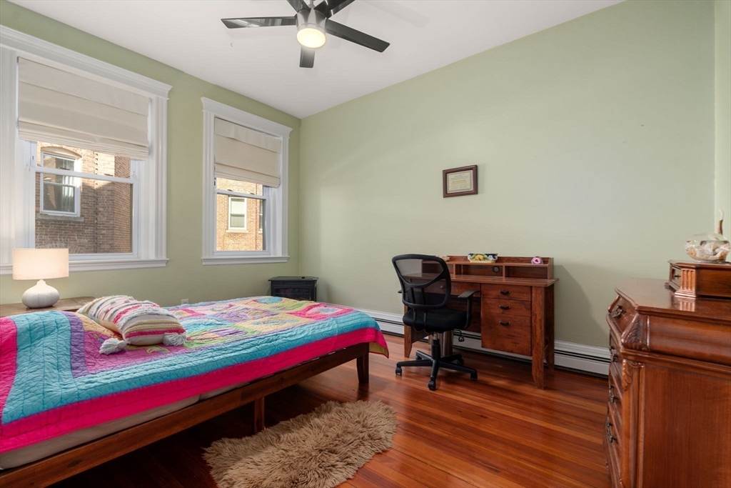7 Parkman Street, Unit 1 Brookline, MA 02446 - Photo 18 of 27 a bed room with a bed and a desk