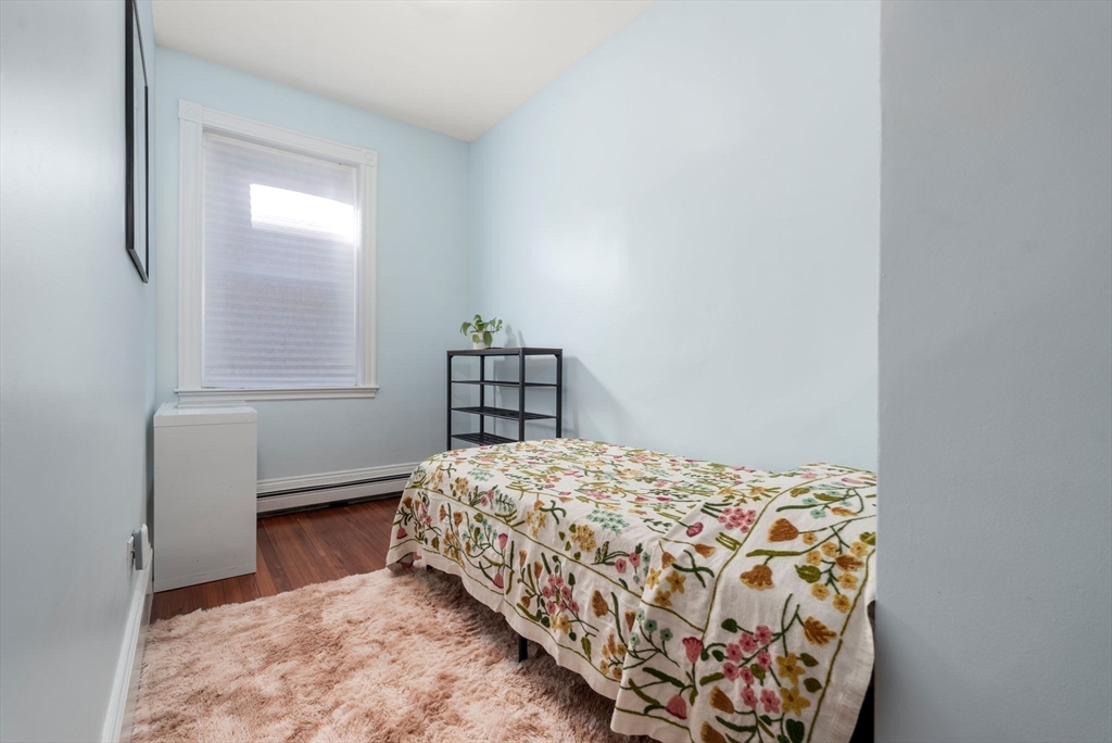 7 Parkman Street, Unit 1 Brookline, MA 02446 - Photo 19 of 27 a bedroom with a bed and a window