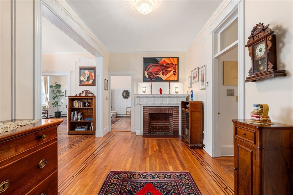 7 Parkman Street, Unit 1 Brookline, MA 02446 - Photo 2 of 27 a bed room with a bed and a television
