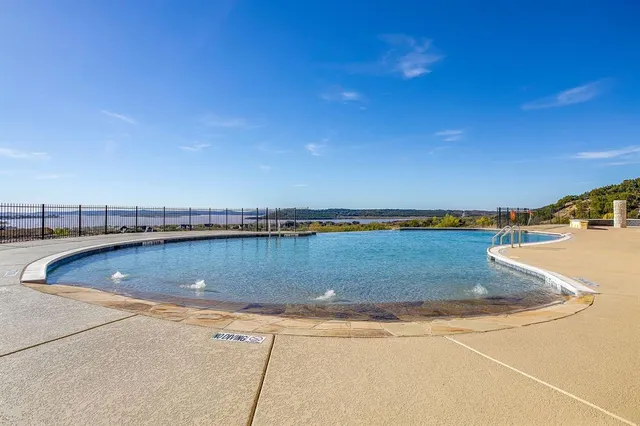 a view of a swimming pool and an outdoor seating