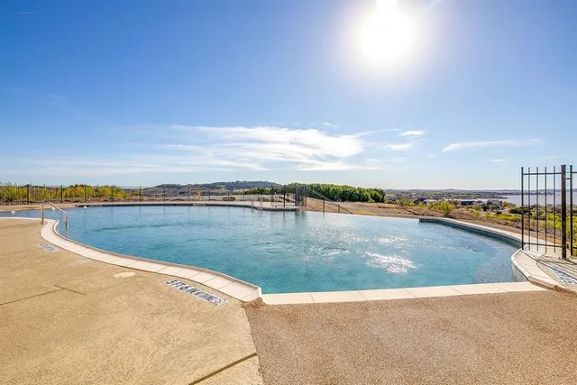 a view of a swimming pool and an outdoor seating