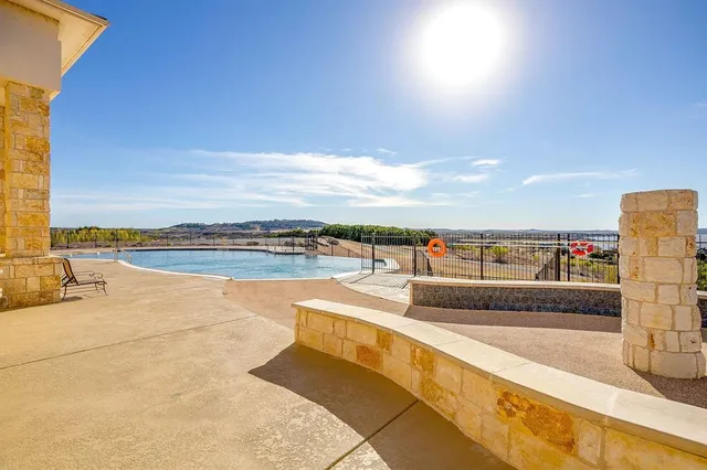 a living room with furniture a large window and wooden floor