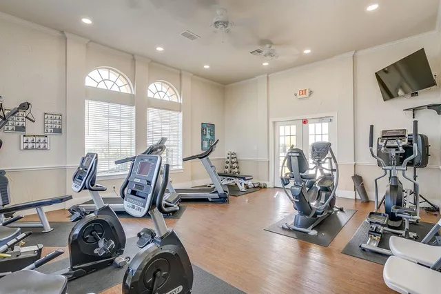 a view of a dining room with furniture and a chandelier