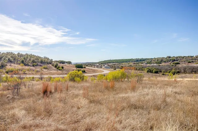 a view of a lake with houses in the background