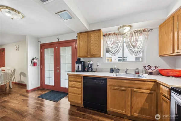 a kitchen with a sink cabinets and wooden floor