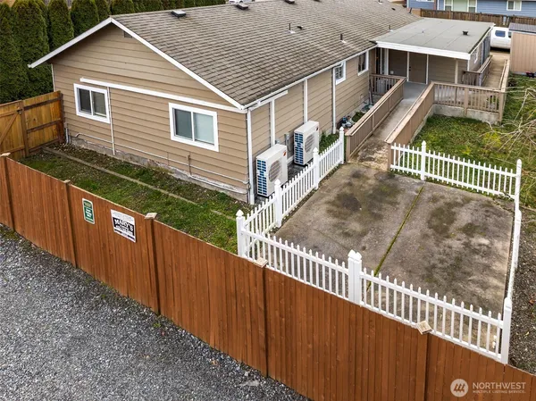 a view of a house with wooden fence