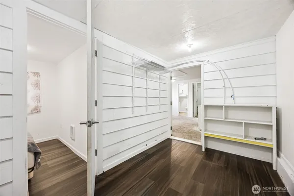 a view of a room with wooden floor and a window