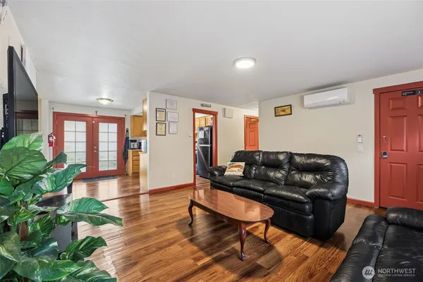 a living room with furniture and a wooden floor