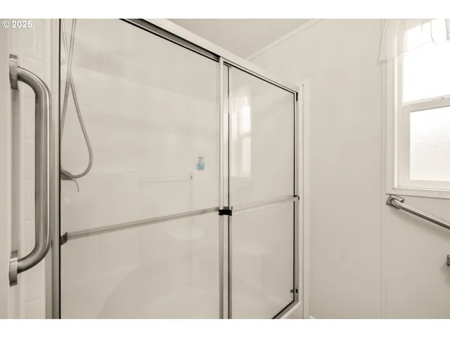 a bathroom with a glass shower door