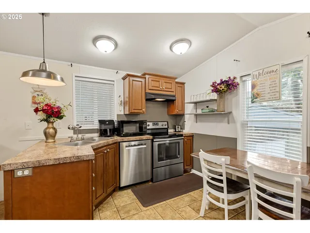 a kitchen with stainless steel appliances granite countertop a sink and cabinets