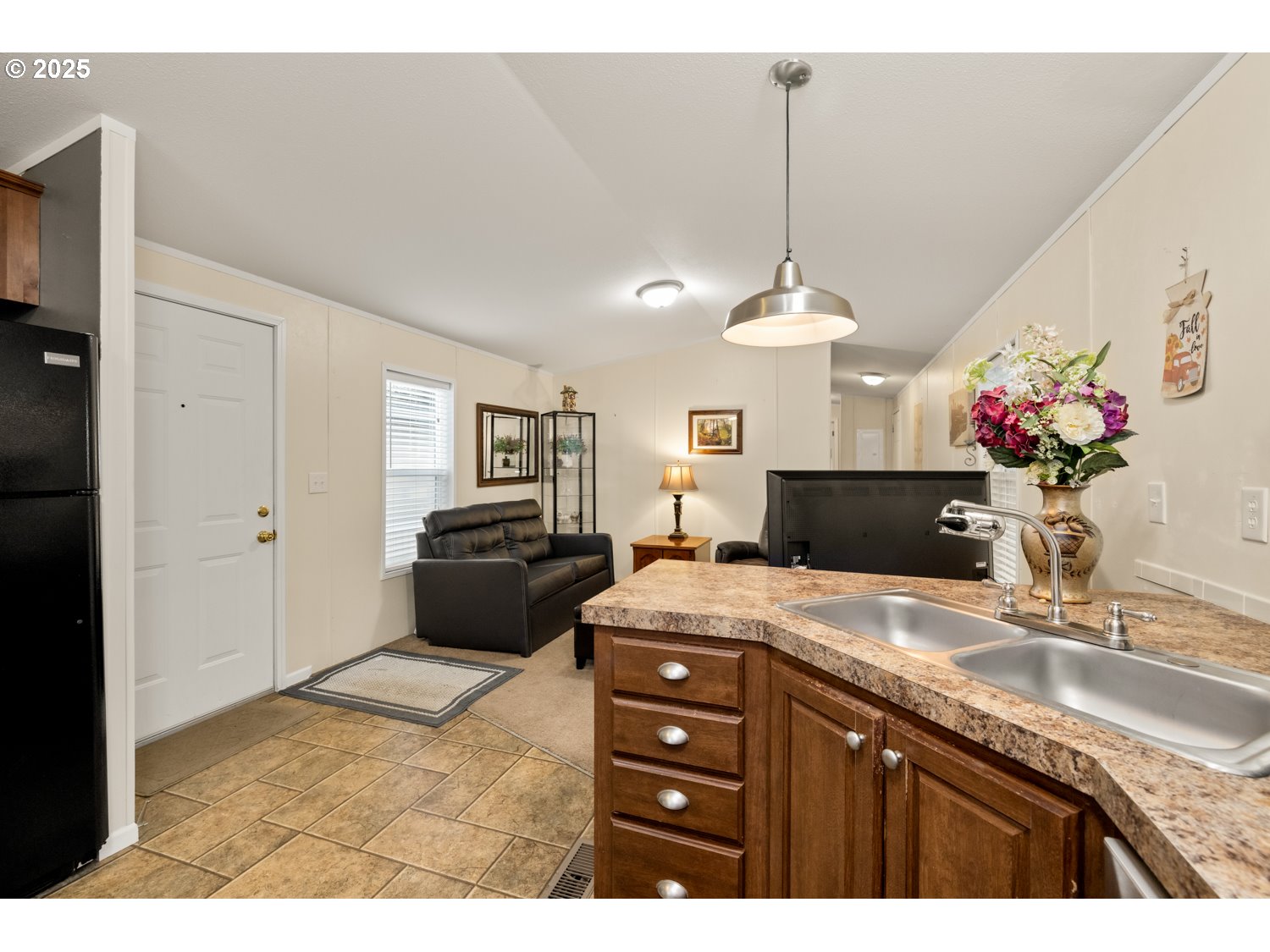 2696 Southeast Palmquist Road Gresham, OR 97080 - Photo 8 of 21 a kitchen with a sink and a refrigerator