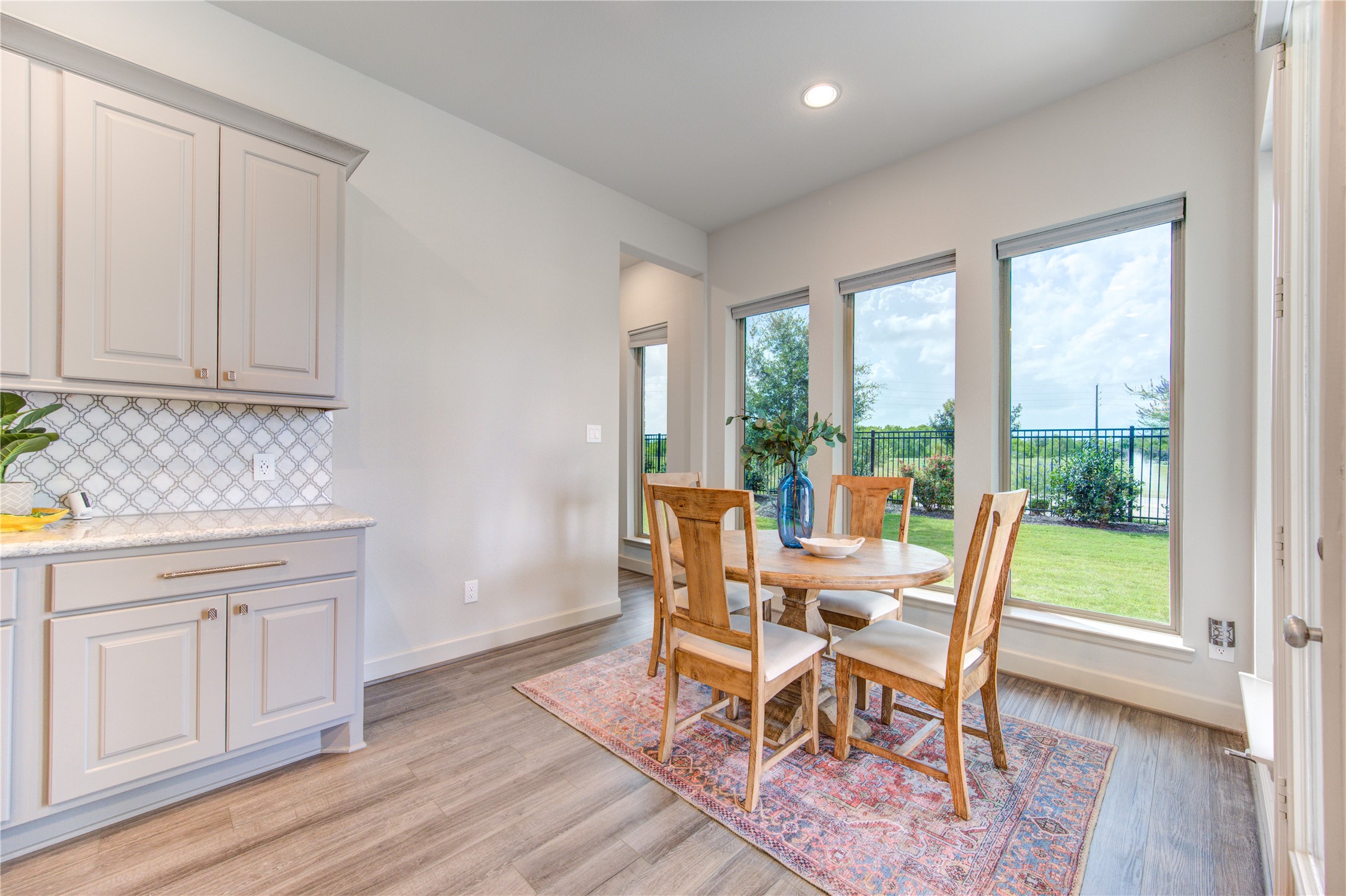 7326 Orangetip Road Katy, TX 77493 - Photo 15 of 43 Casual Dining with Water Views: The sunlit breakfast nook is situated next to the kitchen and offers direct views of the lake, creating a serene and picturesque setting for every meal.