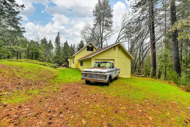 a view of a hallway with wooden floor and entryway