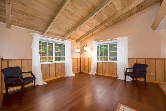 a view of a room with furniture wooden floor and window