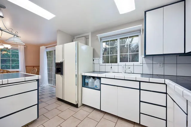 a kitchen that has a stove and a table in it