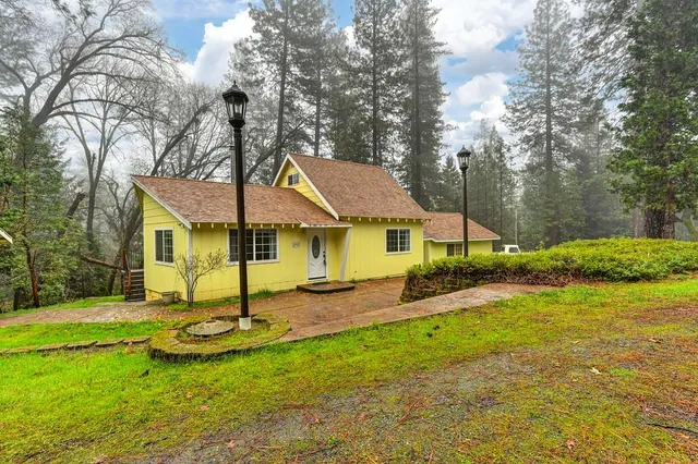 a view of a house with swimming pool and yard