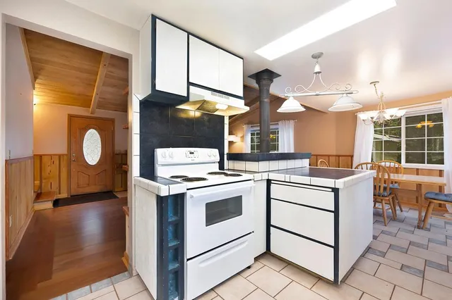 a kitchen with a sink cabinets and window