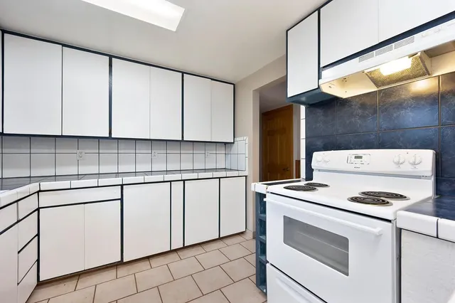a view of a room with a large window and a rug