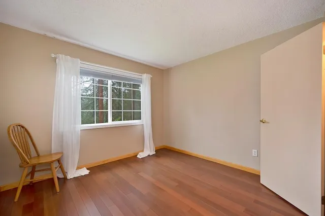 an empty room with windows ceiling fan and windows