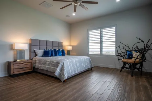 a bedroom with a bed and a chair