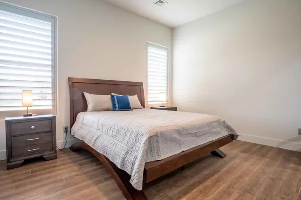 a bedroom with a bed and a window