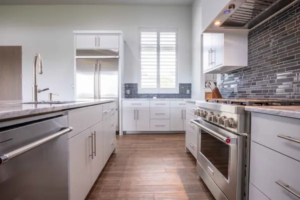a kitchen with a sink stove and cabinets