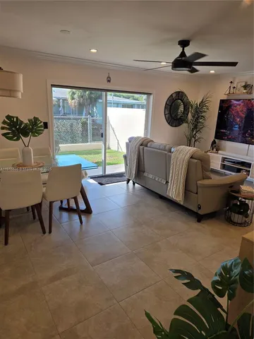 a living room with furniture flowerpot and a potted plant