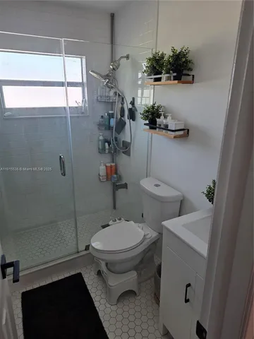 a room with gym equipment and a view of living room