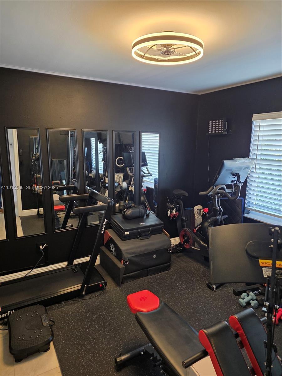 10110 Southwest 20th Street Miami, FL 33165 - Photo 16 of 20 a room with gym equipment and a view of living room