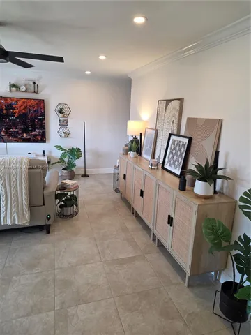 a bed room with furniture and a potted plant