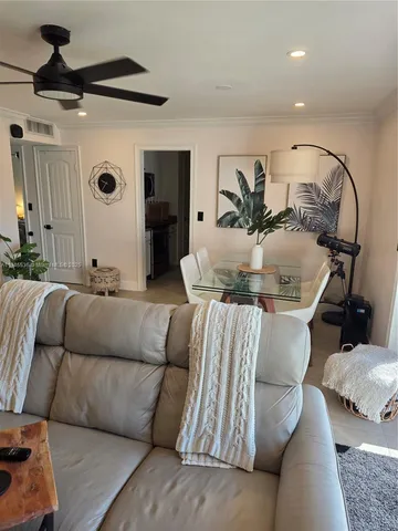 a living room with furniture and a potted plant