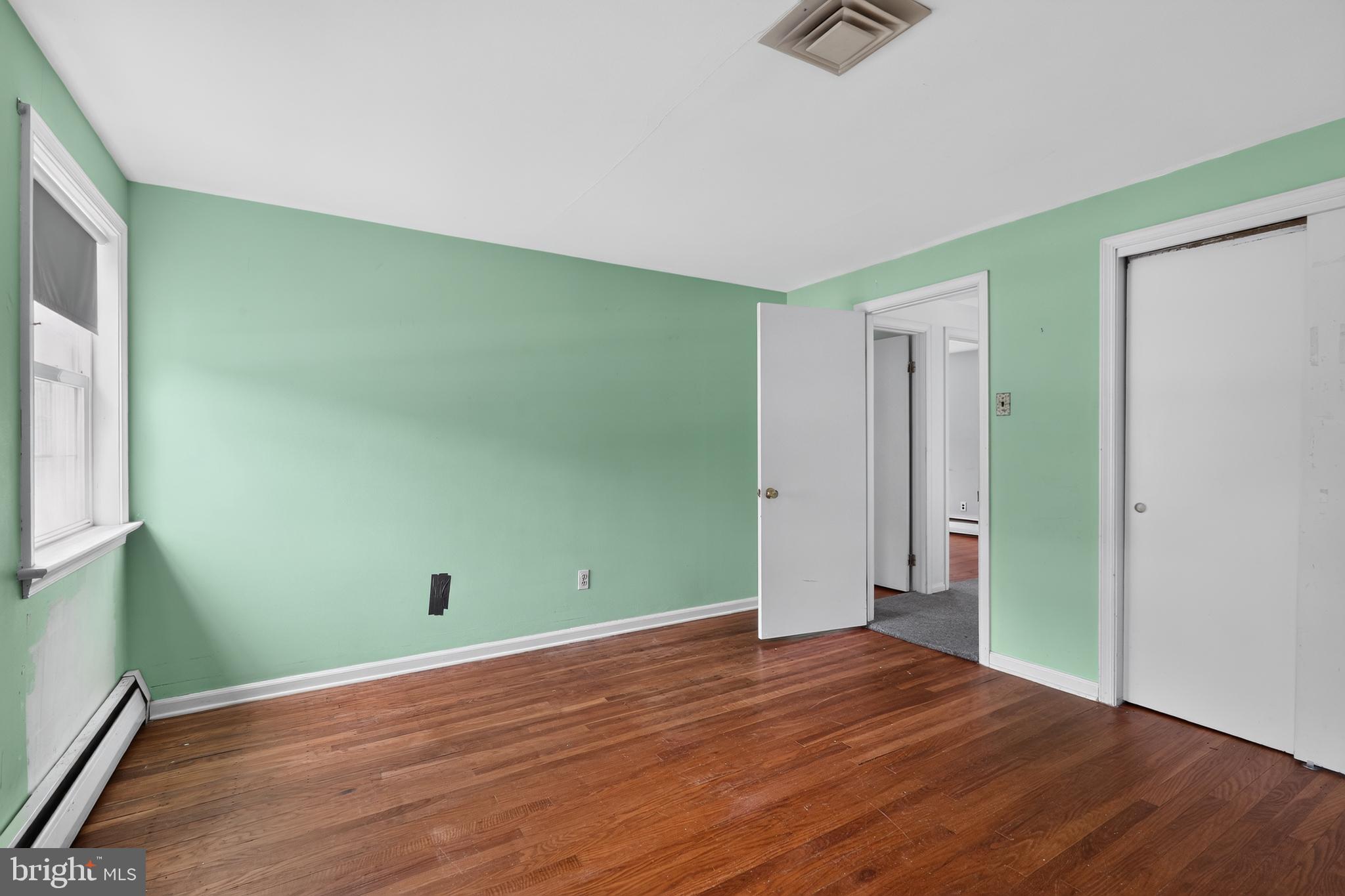 1408 Ponds Edge Road West Chester, PA 19382 - Photo 43 of 53 an empty room with wooden floor and windows