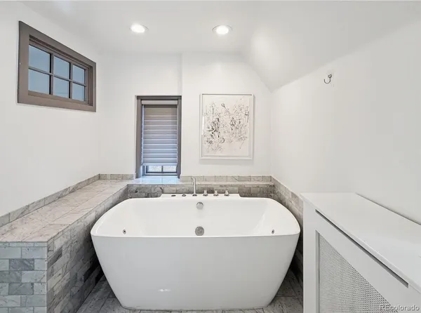 a white bath tub sitting in a bathroom