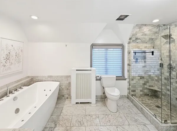 a bathroom with a toilet sink and shower