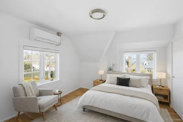 a bedroom with a bed and glass window