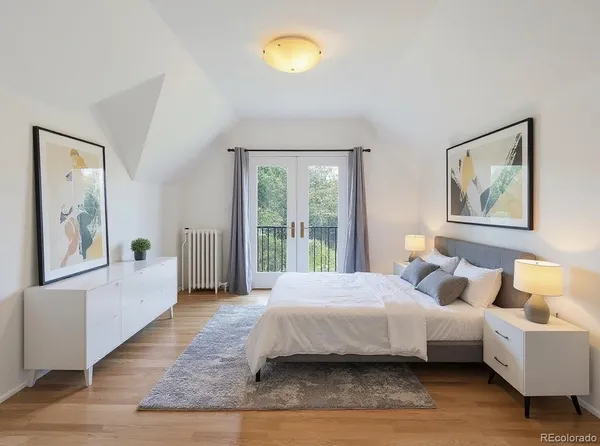 a bedroom with a bed and wooden floor