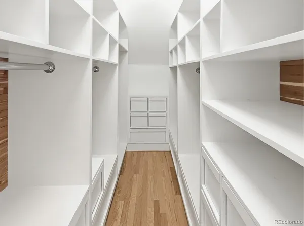 a view of walk in closet with empty racks