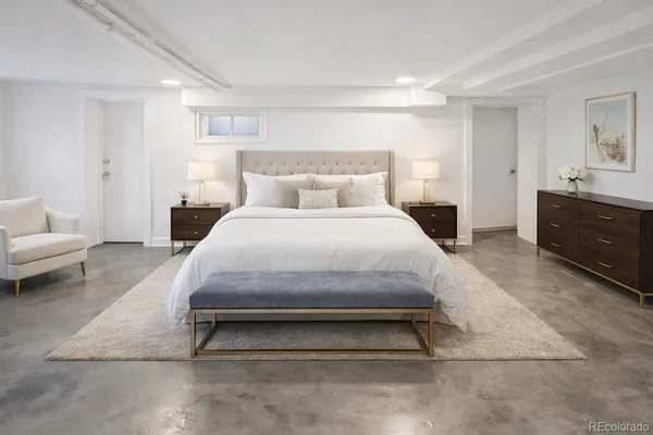 a bedroom with a bed and a couch