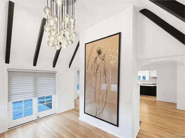 a view of a hallway with wooden floor and staircase