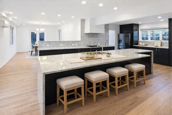 a large kitchen with a table and chairs