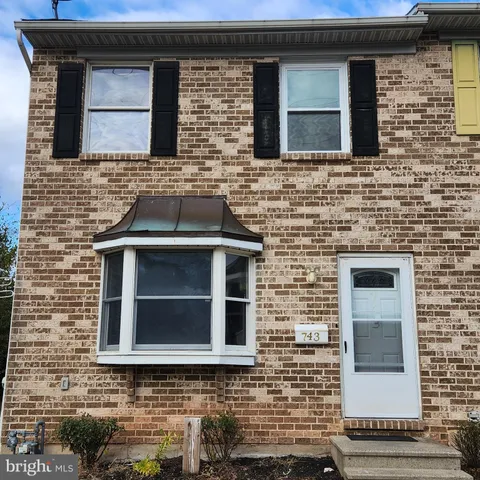 a brick house with a door and a window