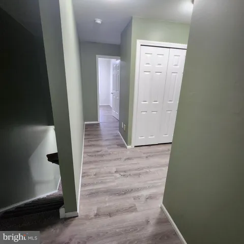 an empty room with windows and stairs