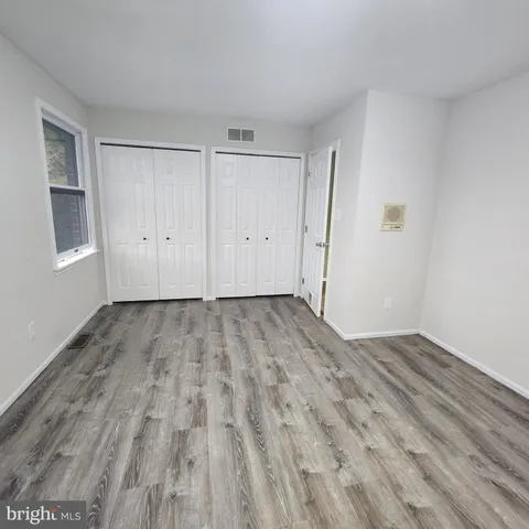 an empty room with an empty space and windows