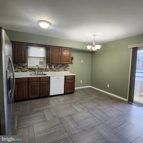 a kitchen with a sink cabinets and stainless steel appliances